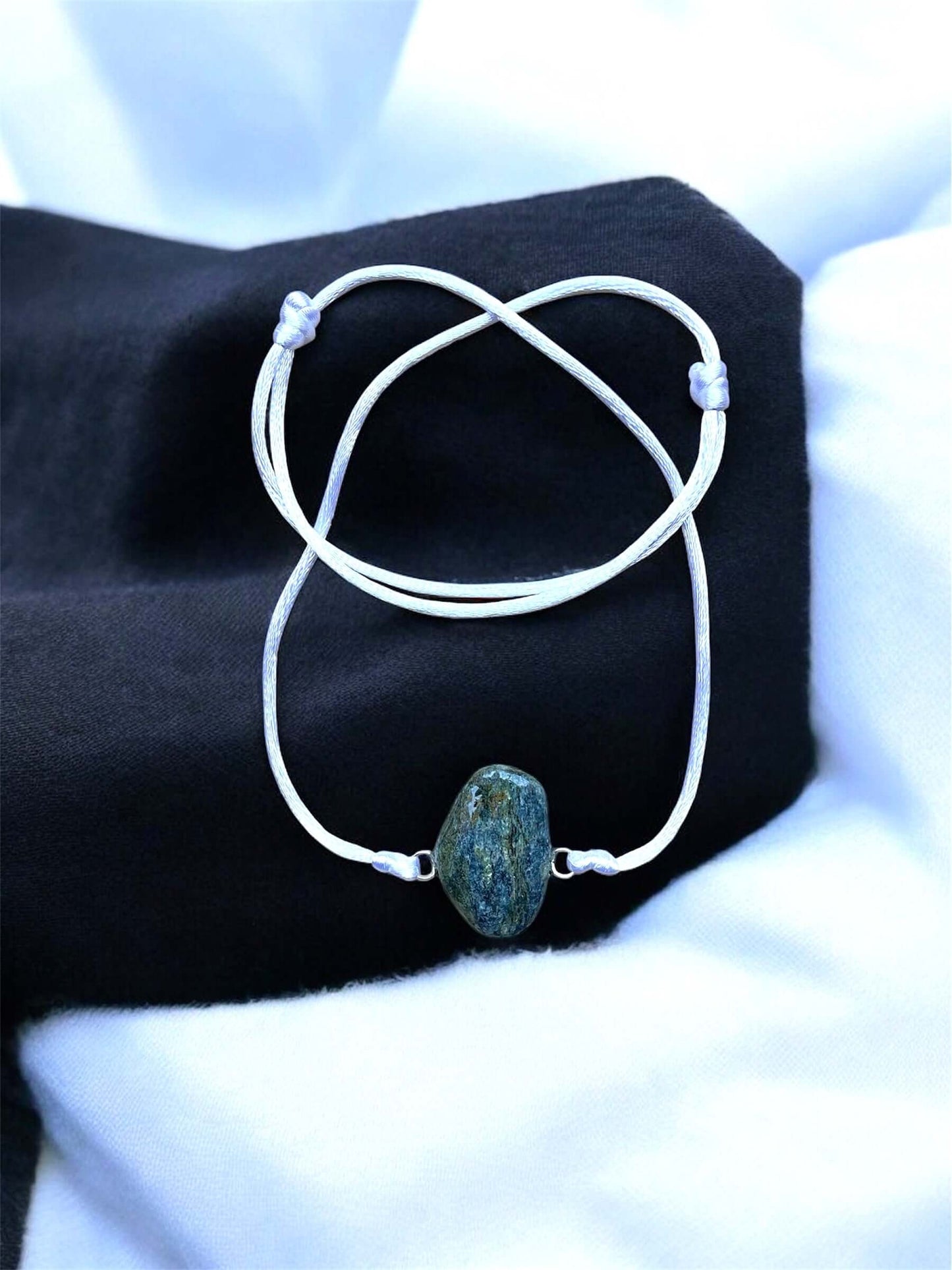 Collier Artigianale con Gemma Naturale dei Fiumi della Valsesia con pietra grezza su sfondo elegante.