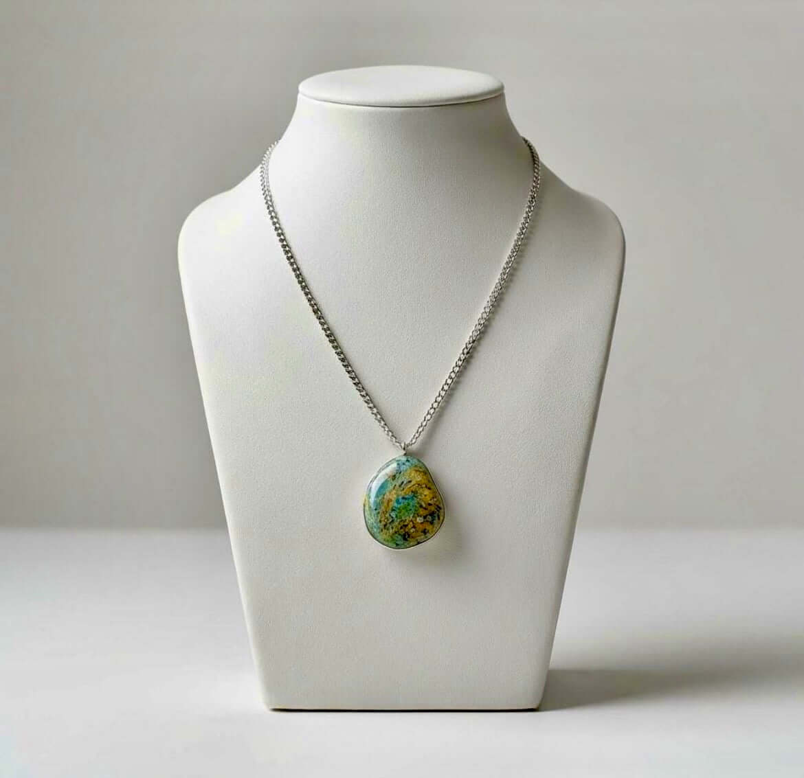 Collana Artigianale con Pietra Minerale Naturale dei Fiumi della Valsesia appesa su un supporto.