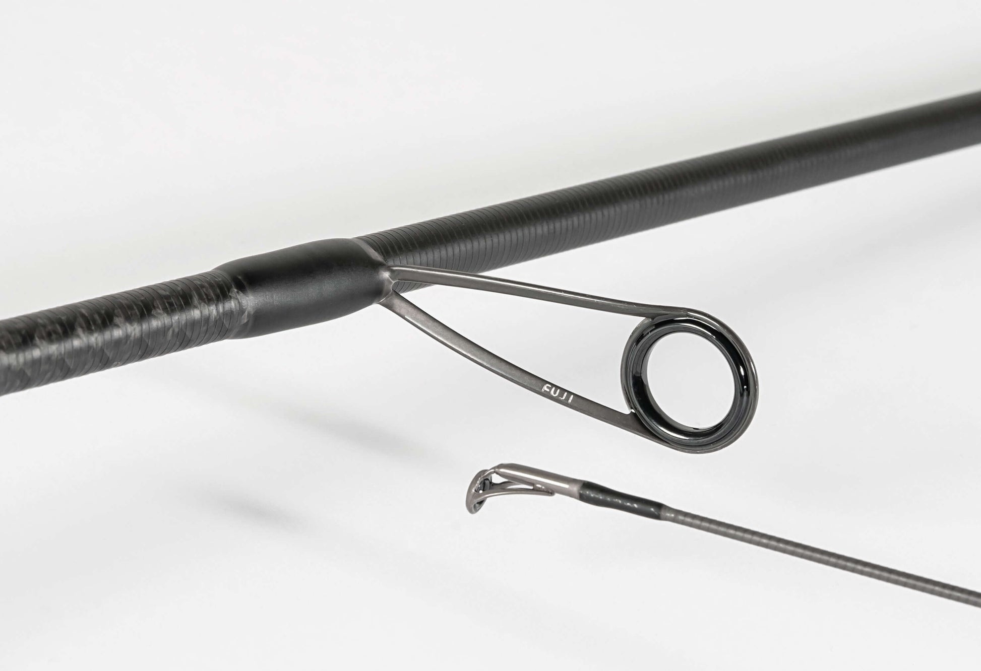  Rapture Black Cross spinning rod showcasing High Modulus Carbon design and Fast/Extra Fast action.