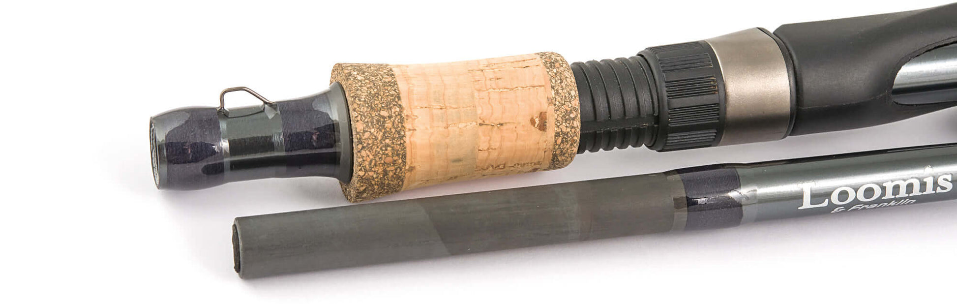 Close-up of Loomis & Franklin Swimbait & Jerk IM7 fishing rod showing cork handle and graphite sections.